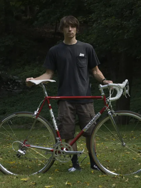 Parker standing behind a red Colnago road bike